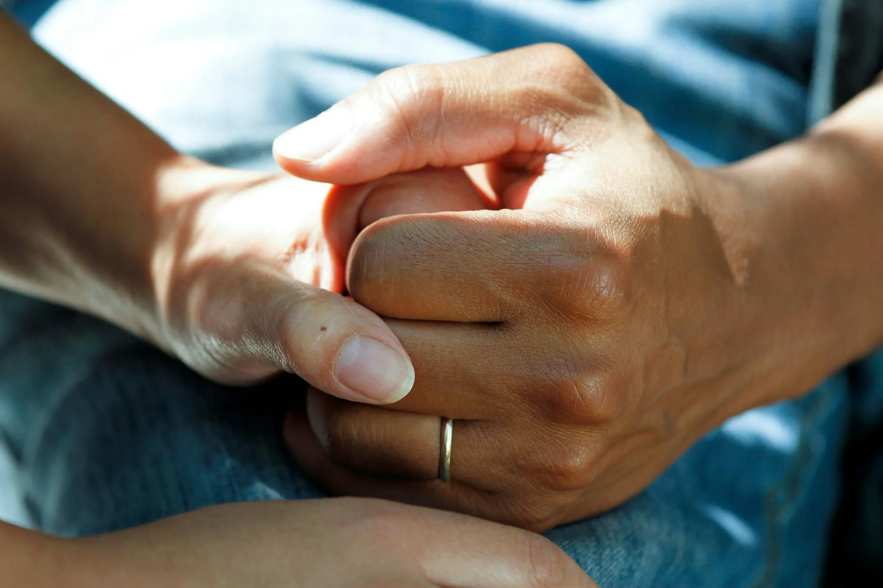 Hands supporting a patient in a calm clinical home-care setting